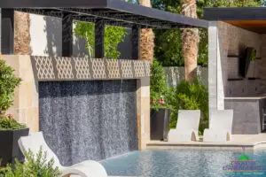Backyard design with shaded water wall into pool