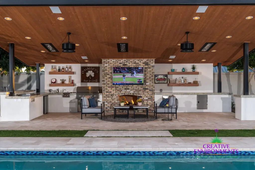 Custom backyard design with deco-tile pool, recessed lighting and outdoor BBQ.