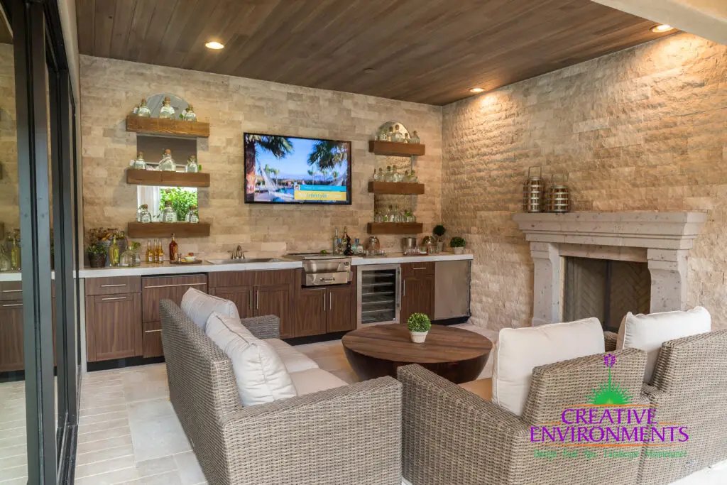 Custom backyard design with natural wood accents, fireplace and outdoor bar.
