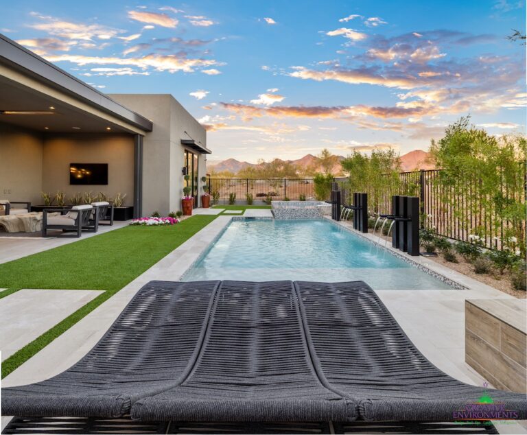 Custom backyard design with multiple water features, deco-tile pool and raised spa.
