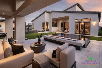 Custom backyard design with fire table, artificial turf and multiple seating areas.