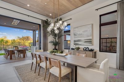 Custom backyard design with mountain views, multiple seating areas and metal fencing.