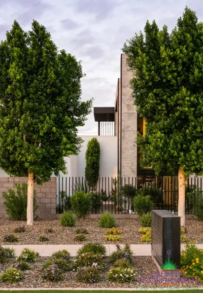 Custom front yard design with trees and organized planting.