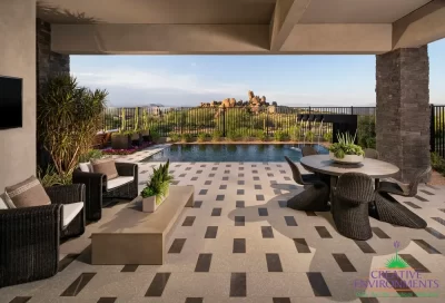 Custom backyard design with multiple seating areas, metal scupper water feature and metal fencing.