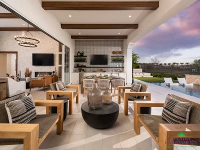 Custom indoor/outdoor fusion with wooden ceiling beams, multiple seating areas and pool with baja step.