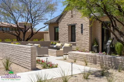 Custom entryway design with fire table, organized planting and privacy wall.